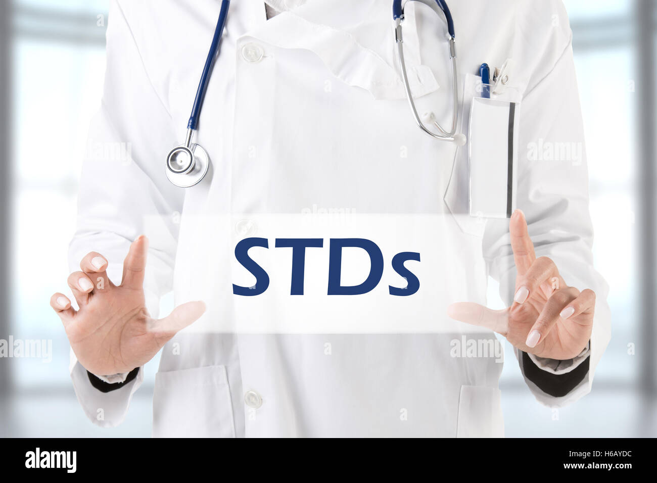 Image of a doctor in a white coat holding a sign that says "STDs".